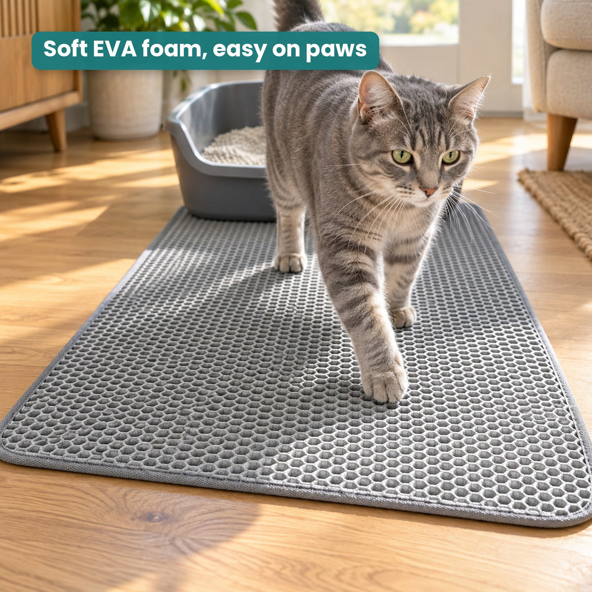 A tabby cat walking across the grey honeycomb mat